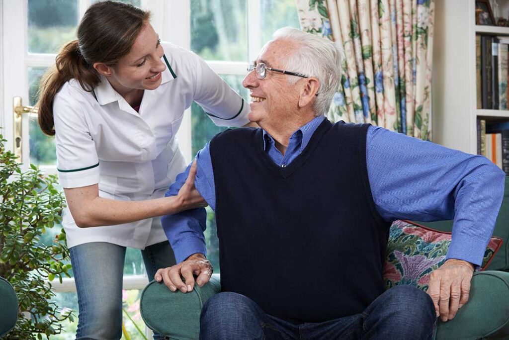 Older adult arranging personal belongings in a bright assisted living apartment with a family member.
