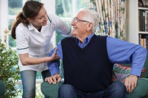 Older adult arranging personal belongings in a bright assisted living apartment with a family member.